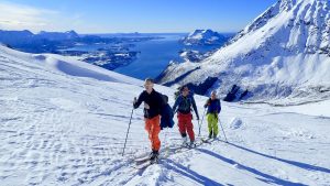 Tre skigåere på topptur i klarvær