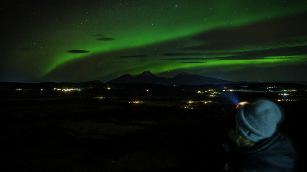 The Northern Lights over the island Dønna seen from partly up the Seven sisters