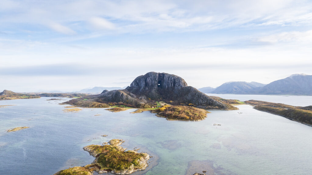 Sagnfjellet Torghatten and the hiking trail around and through the mountain on a fine autumn day with autumn colors on the trees