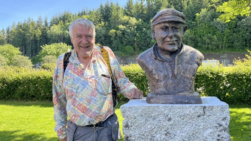 Billedhugger Svein-Tore Kleppan med bronsebysten av Arnt O. Åsvang som ble avduket søndag den 13. juli 2025.