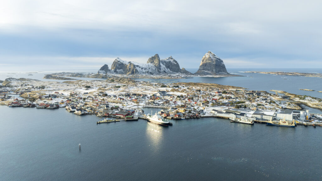 The island of Husøy in Træna with the Træna Mountains in the background on a nice winter day